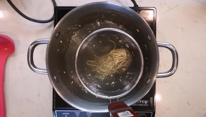 Cook your ramen noodles according to package instructions and strain well.