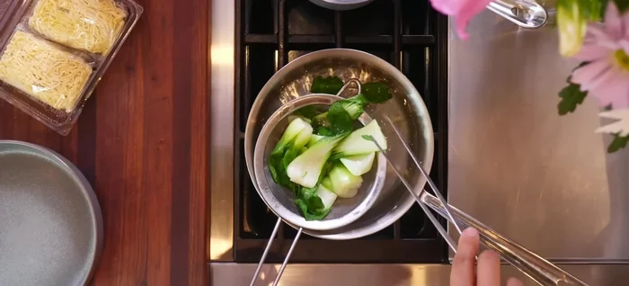 Blanch bok choy and bean sprouts. Set aside.