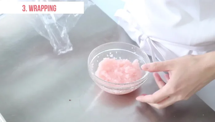 Divide the dough into three portions. Place one portion on the center of a piece of plastic wrap. Use a spoon to spread the dough into a circle (wet your spoon to help spread it).