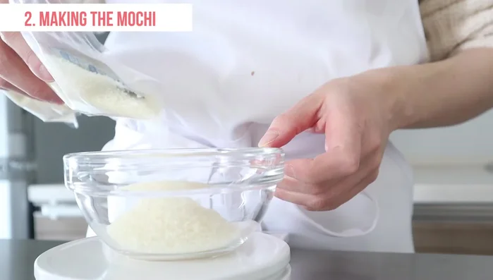 Place dooji powder (or sweet rice) in a microwave-safe container. Add hot boiling water, a small amount of food coloring, and stir. Cover with plastic wrap and let it sit for 5 minutes.