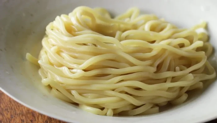 Dip the noodles into the hot broth to enjoy.