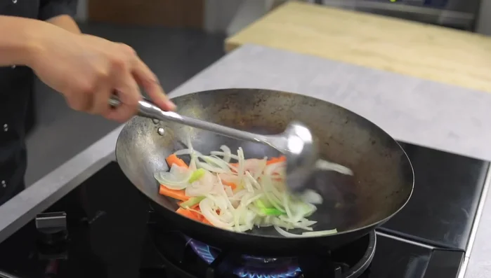 Add carrots. Stir-fry until slightly softened.