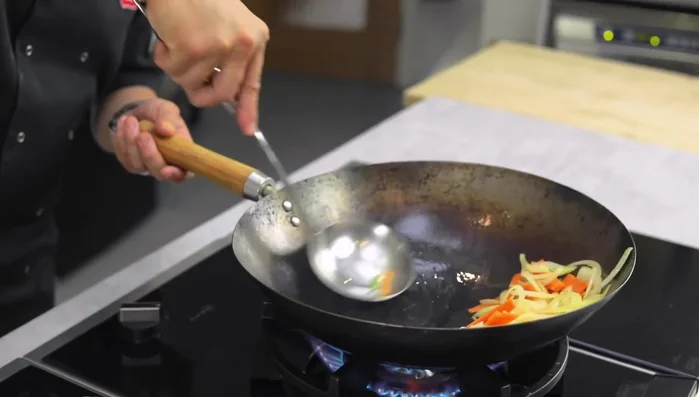 Add chicken to the wok and sear until cooked through.