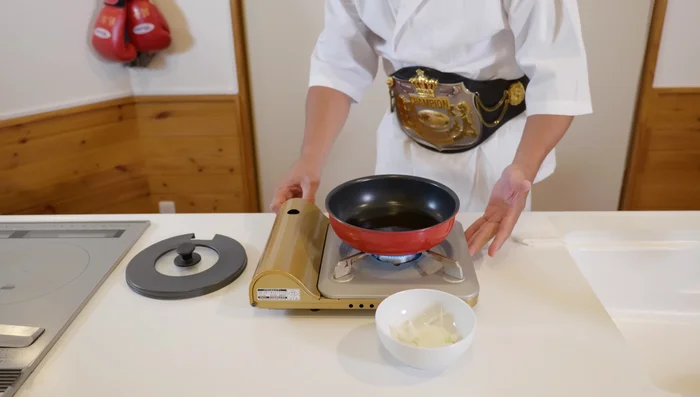 Assemble katsudon: In a frying pan, add kashi sauce and cook over medium heat. Add onions and cook for about a minute until translucent.