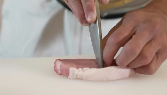 Make small cuts in the pork where fat connects to prevent curling. Use a tenderizing gadget or fork to make small holes in both sides. Season with salt and pepper.
