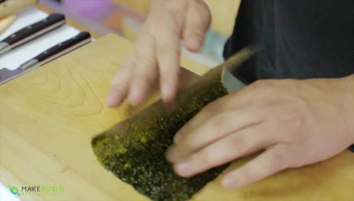 Cut the nori sheet in half.