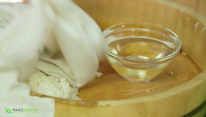 Spread the cooked sushi rice onto the nori sheet, leaving a gap at the top.