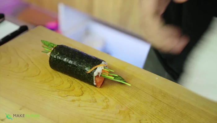 Wrap the futomaki roll in the daikon sheet.
