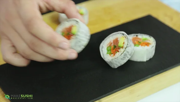 Arrange the sushi rolls for presentation.