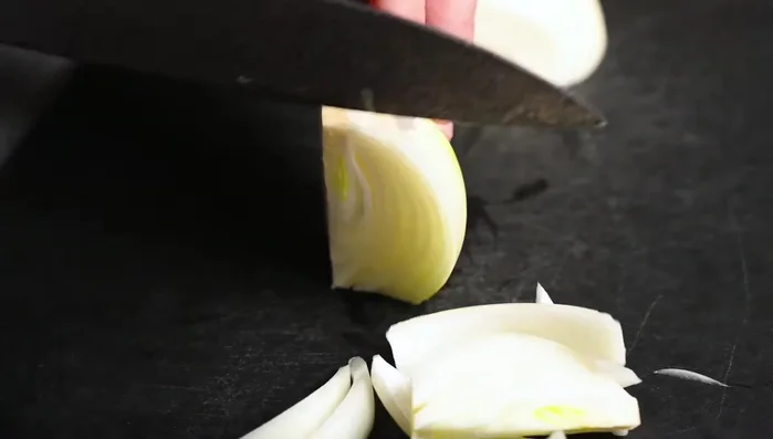 Prepare the onions: Cut half an onion into chunky pieces. (100.159)