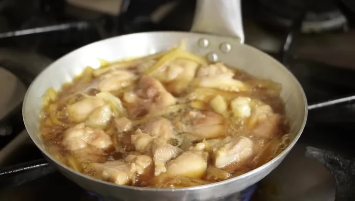 Once chicken is 90% cooked, turn heat to high. Add spring onions.