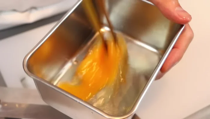 Whisk one egg, but don't overmix to maintain fluffiness.