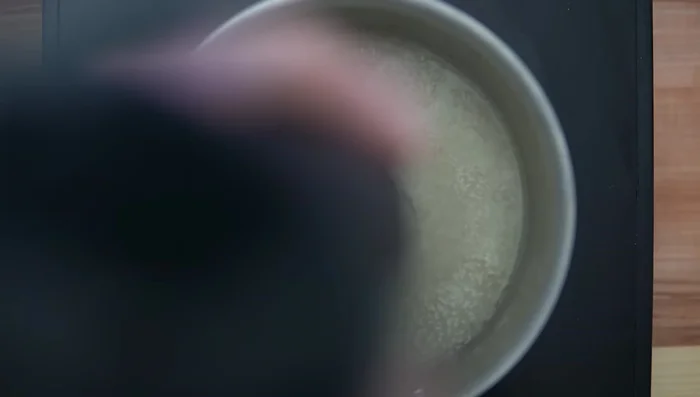 Heat the soup, emulsify using an immersion blender.