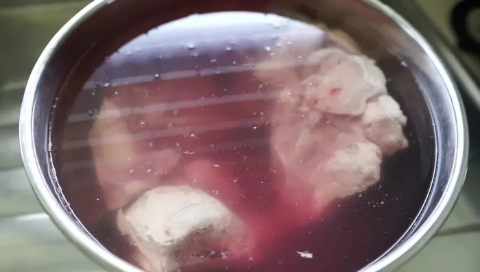 Soak pork bones for a few hours to remove myoglobin (discoloration).