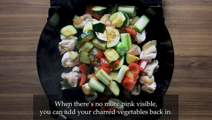 Combine and thicken the sauce: Add the cooked vegetables and prepared sauce to the pan with the chicken. Stir continuously until the sauce thickens.