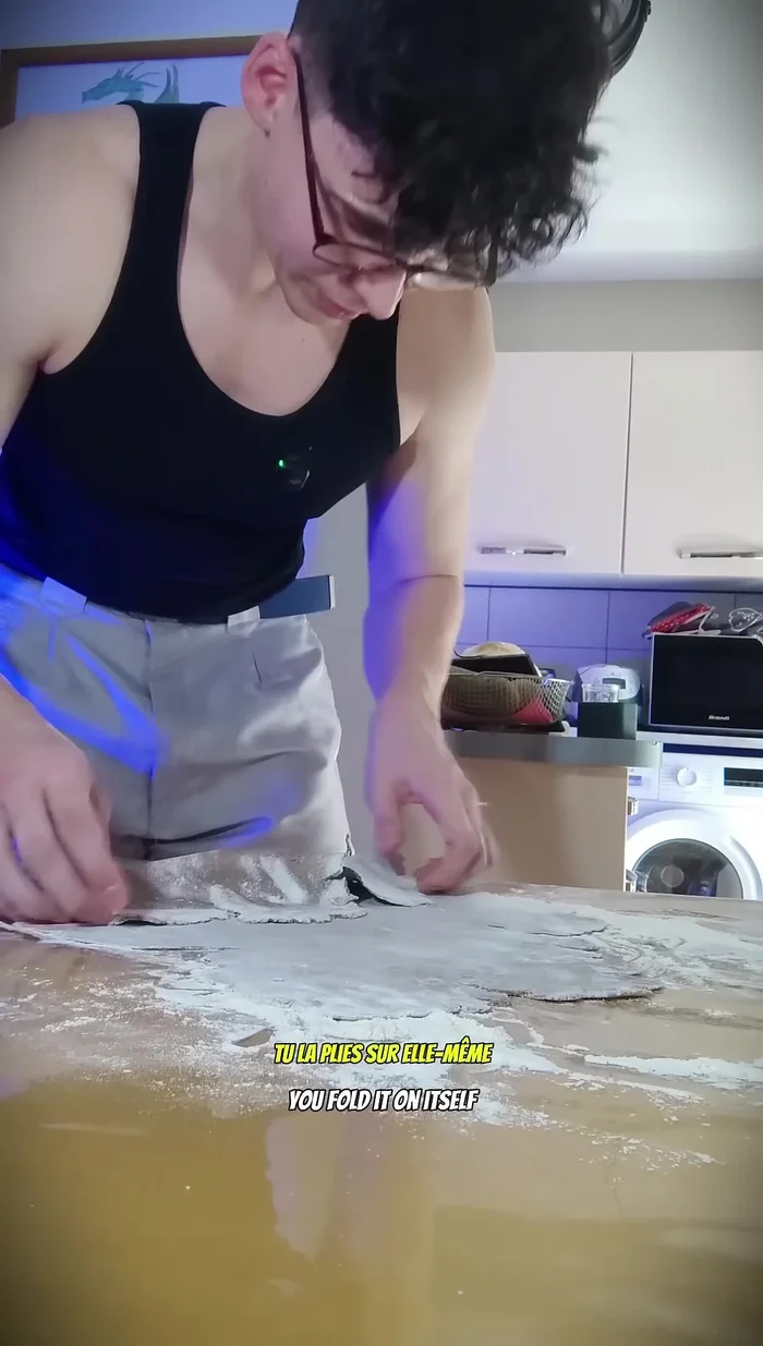 Fold the dough, add flour, and fold again. Repeat as needed.