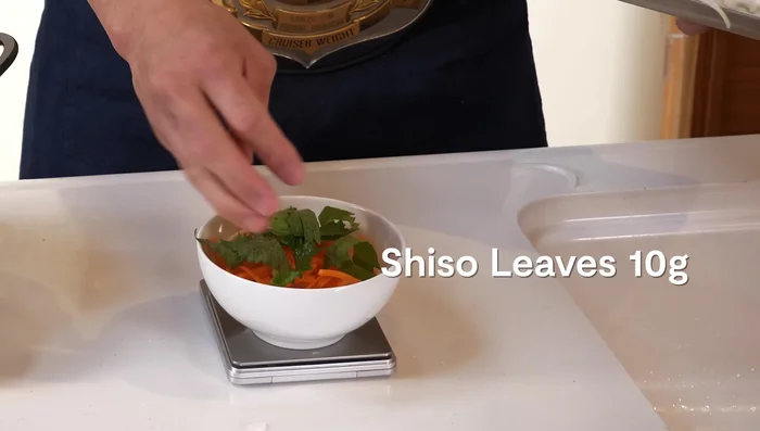 Prepare kakeage: Combine onion, carrot, shiso leaves, flour, and tempura batter. Fry in the oil using a mold or spoons, shaping as desired.
