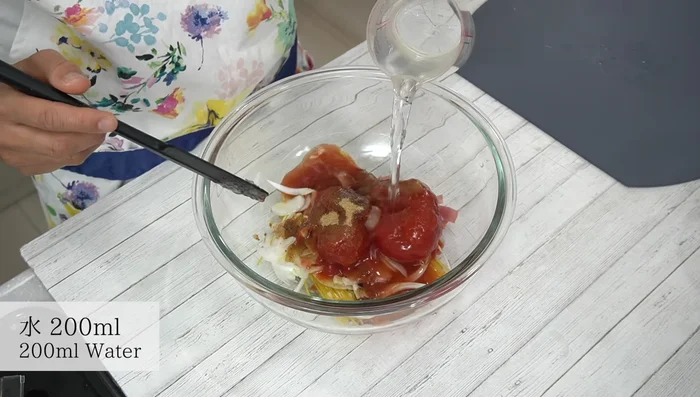 Add water, crush tomatoes slightly, and mix lightly.