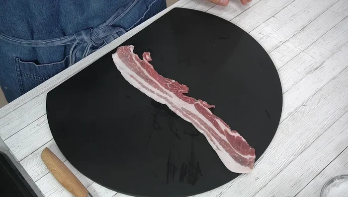 Sprinkle salt and pepper on pork belly slices.