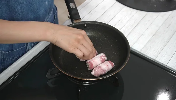 Sear the rolled pork belly until browned on all sides, removing excess oil as needed.