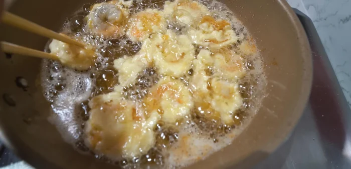 Dip vegetables in the batter ensuring they are fully coated. The video shows how it's done.