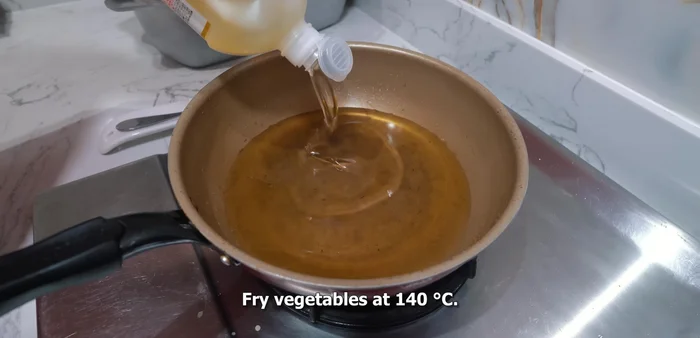 Heat oil in your frying pan to approximately 180 degrees Celsius (or 160 degrees according to a later segment).