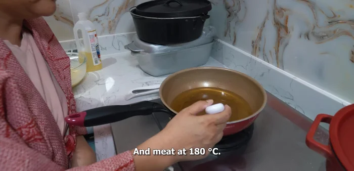 Carefully place the battered vegetables into the hot oil, frying until golden brown and crispy.