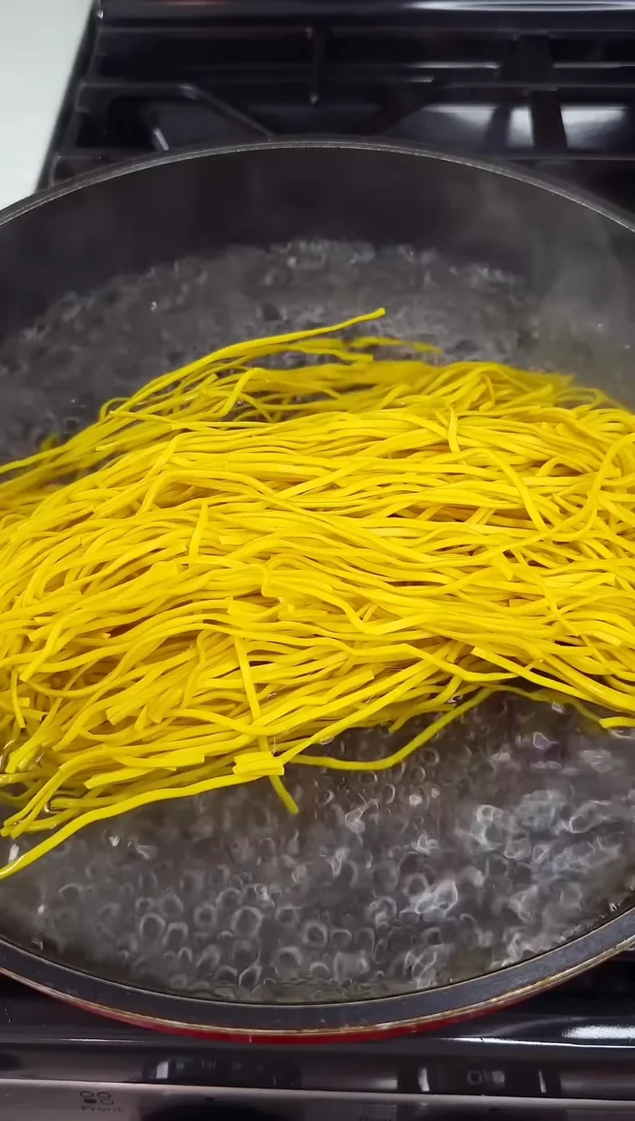 Boil chow mein noodles for 10-15 minutes, then drain and set aside. (Start: 32.52)