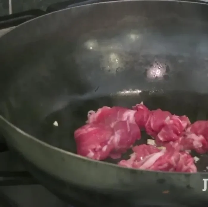 Add thinly sliced pork (or other meat like chicken, beef, or shrimp) and cook until browned at medium heat.