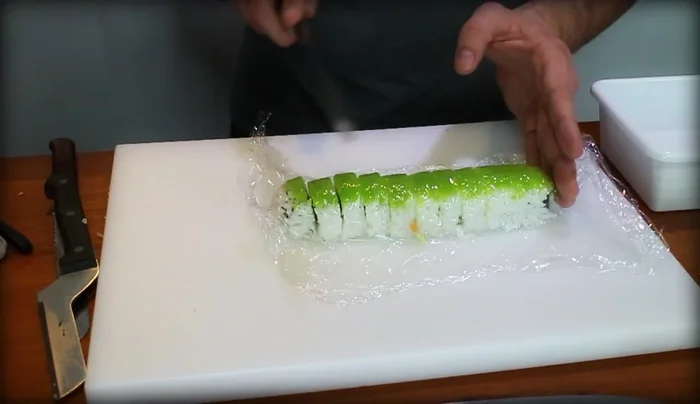 Cut the sushi roll in half, then into quarters, and finally into eights (or more, depending on preference). Aim for thin, even slices.