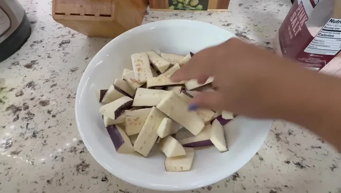 Prepare the Japanese eggplants by slicing them and setting aside.