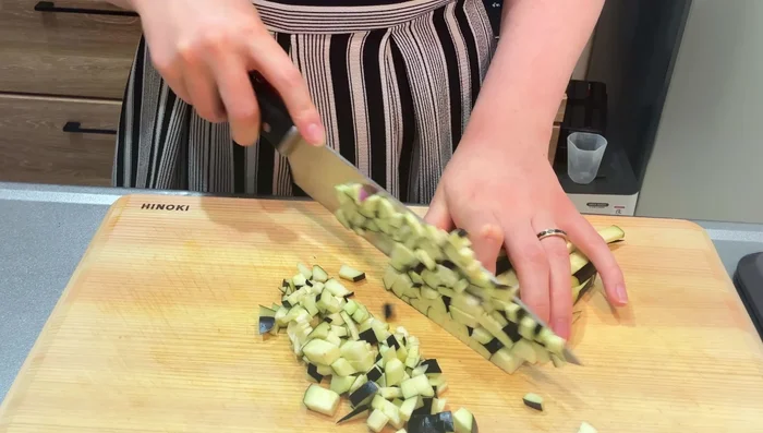 Cut eggplant into small cubes and dice the onion.