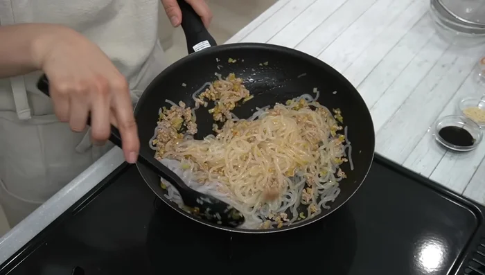 Add shirataki noodles and mix well. Add soy sauce, sugar, sake, chicken soup base, and water. Mix well and simmer for about a minute.