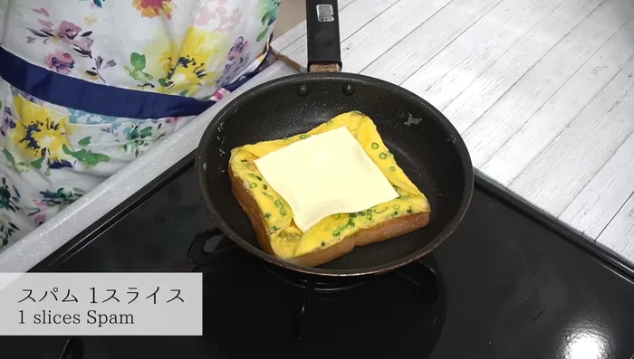 Place a slice of cheese in the middle, add Spam to one side, and a moderate amount of ketchup to the other side.