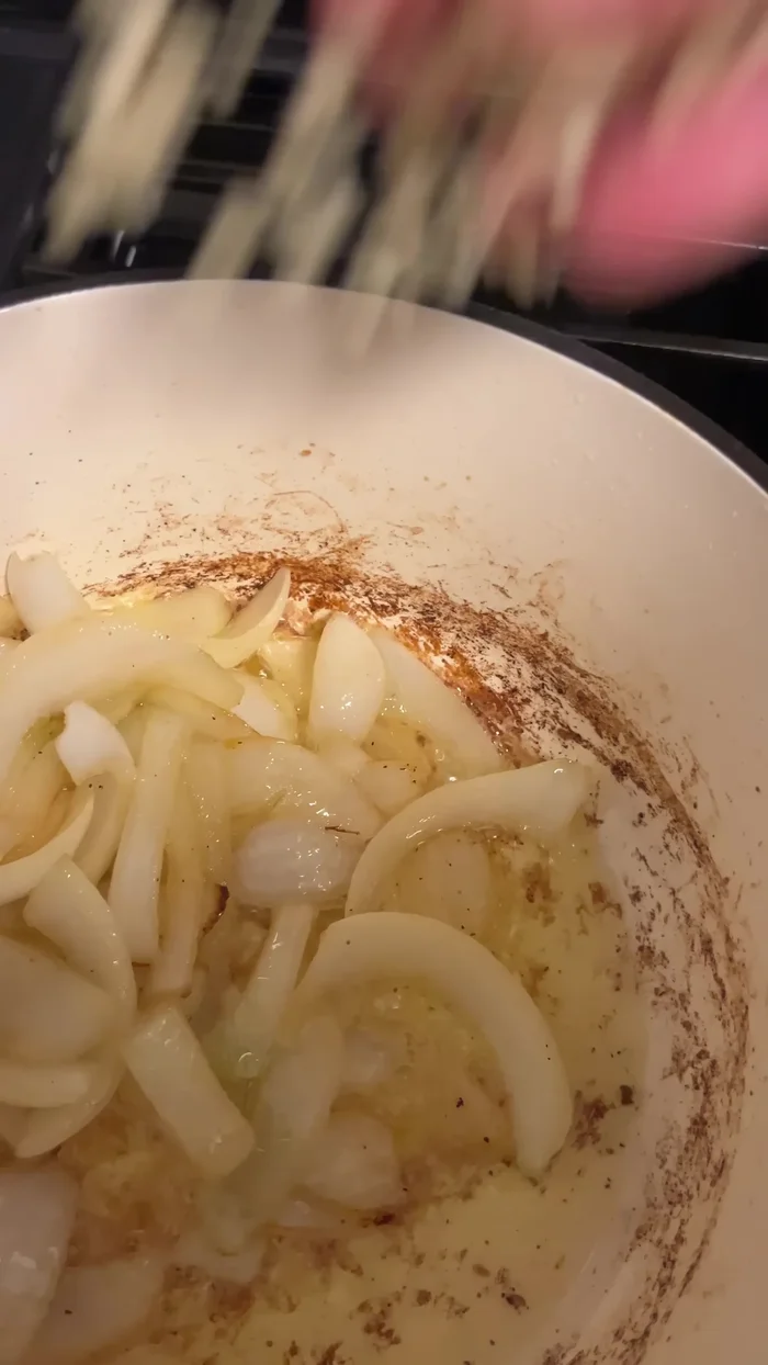 Add onions, garlic, carrots, and blueberries to a pot.