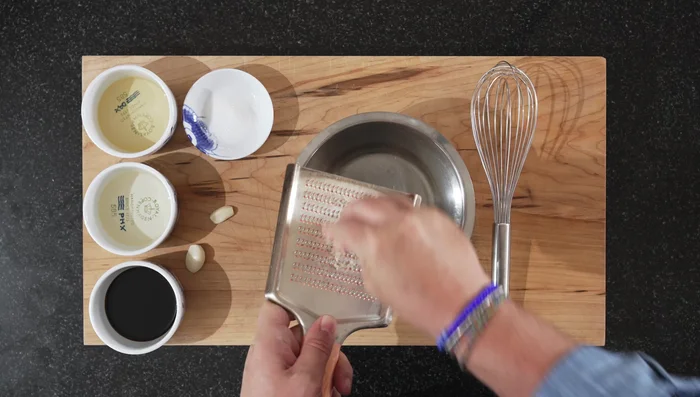 Grate the garlic cloves. (If you dislike garlic, omit this step)