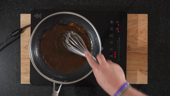 Pour the reserved marinade into the pan and bring to a simmer. Reduce the sauce until it thickens, stirring occasionally to prevent burning.