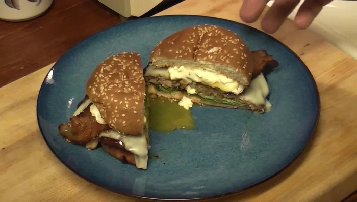 Assemble the burger: Place the pork patty on a bun. Add a slice of cheddar cheese, bacon, and the cooked egg.