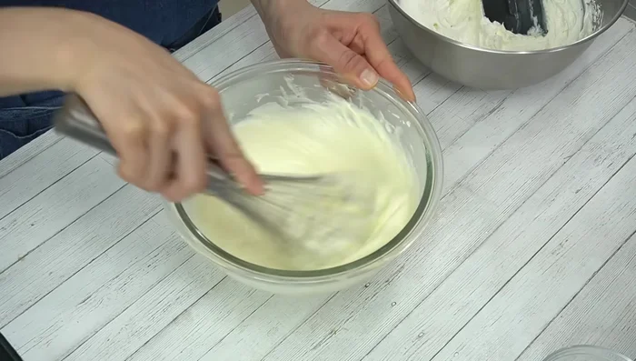 Gradually add whipped cream to the cream cheese mixture, folding gently until combined.