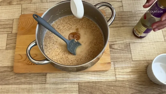 Add sesame oil, rice vinegar, soy sauce, mirin (or sugar/honey), salt, pepper, and lemon zest to the saucepan.