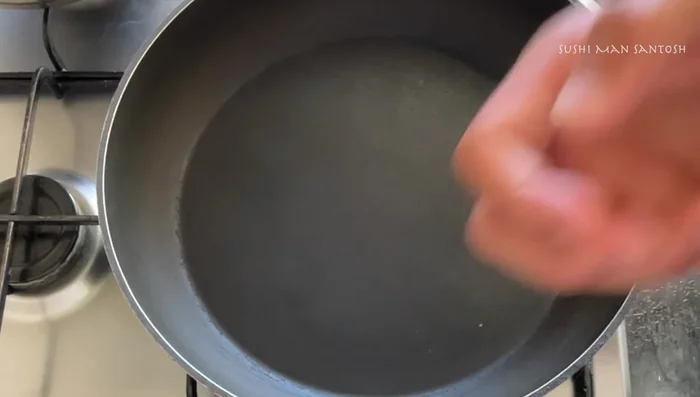 Toast white sesame seeds in a pan over low heat until fragrant. Let cool, then grind them using a mortar and pestle or food processor.