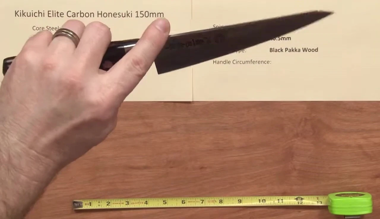 The reviewer assesses the knife's sharpness.