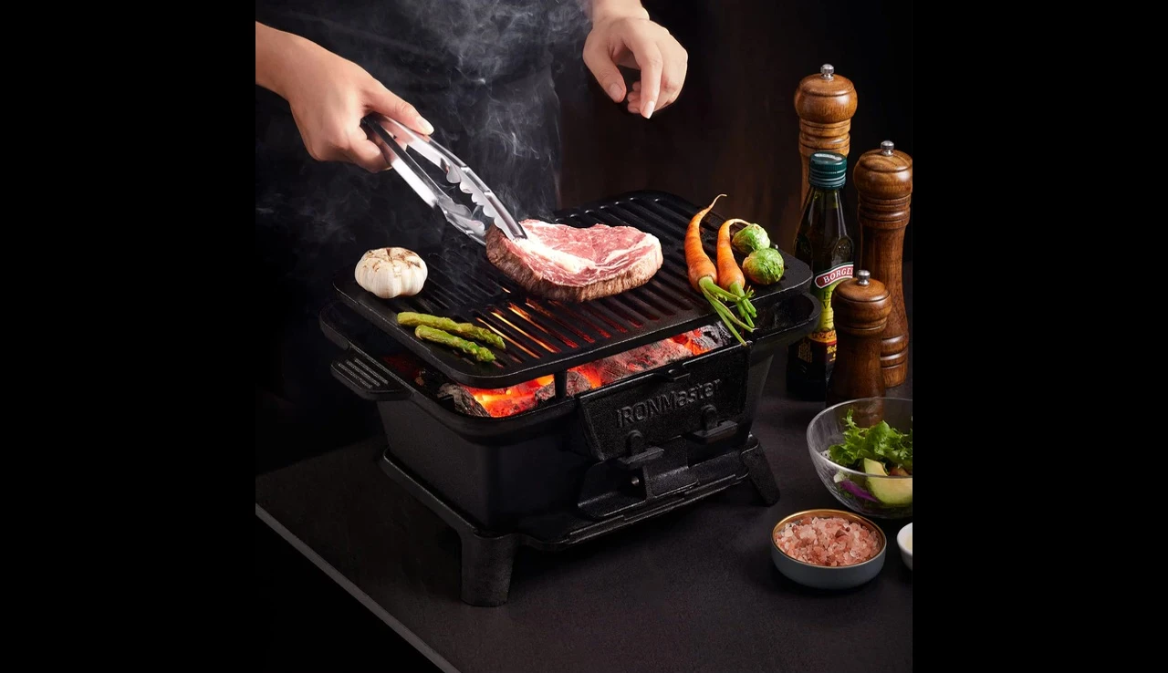 The IronMaster Hibachi grill being used at a campsite.